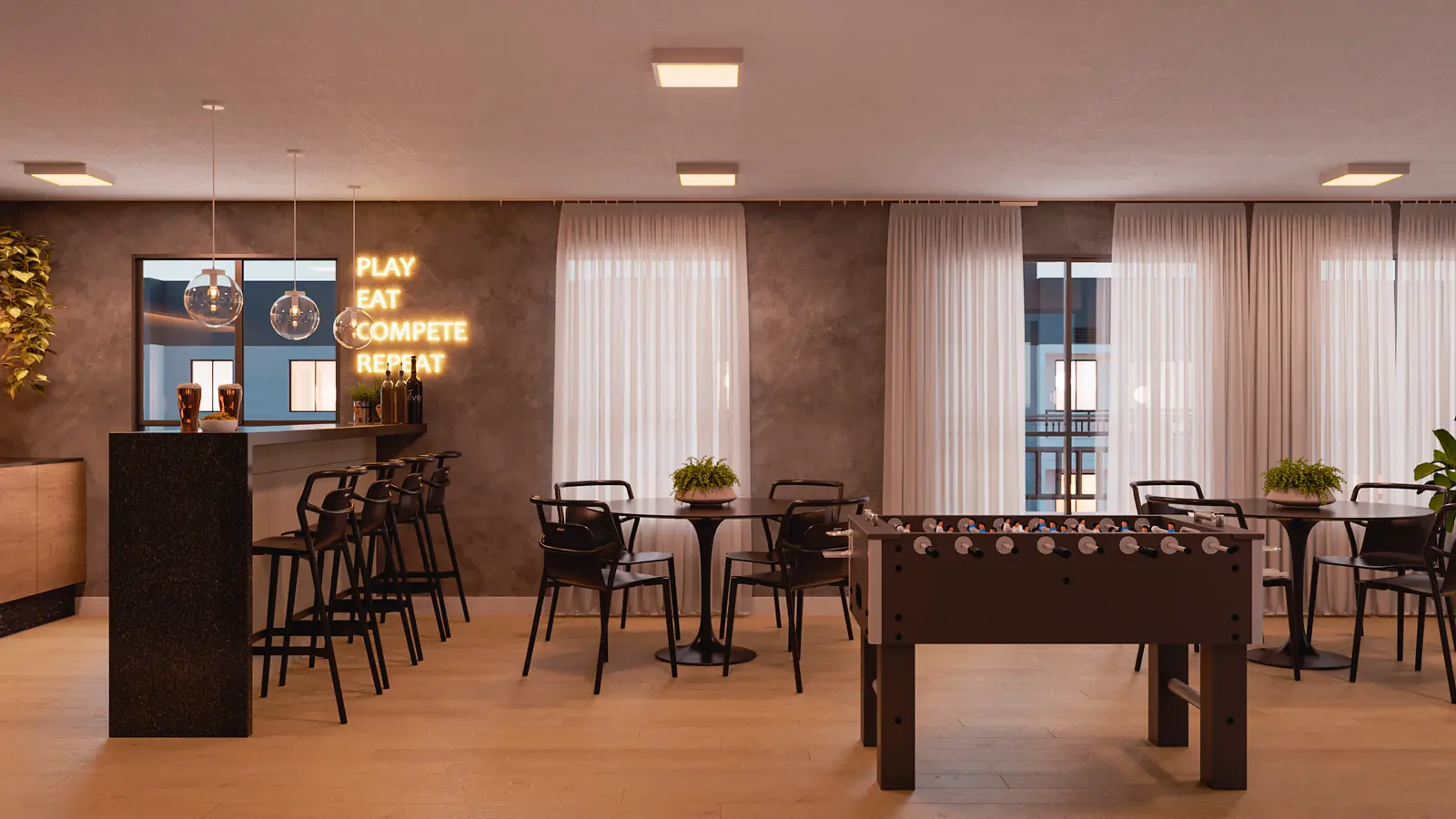 Living II do rooftop do Hype Condomínio Clube, com mesas altas, banquetas e mesa de pebolim