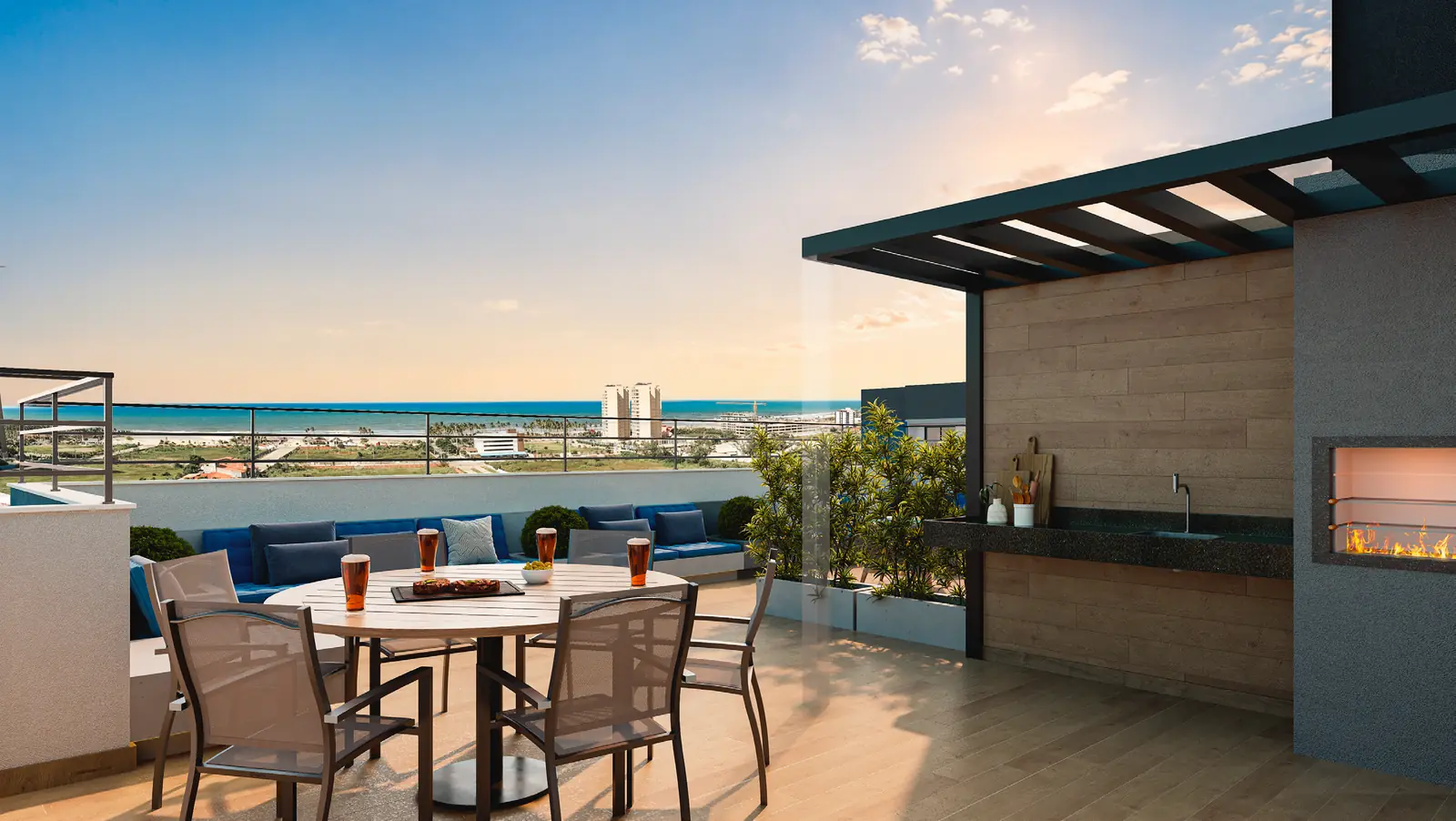 Living externo do rooftop do Hype Condomínio Clube, com mesas, cadeiras, churrasqueira e vista para o mar