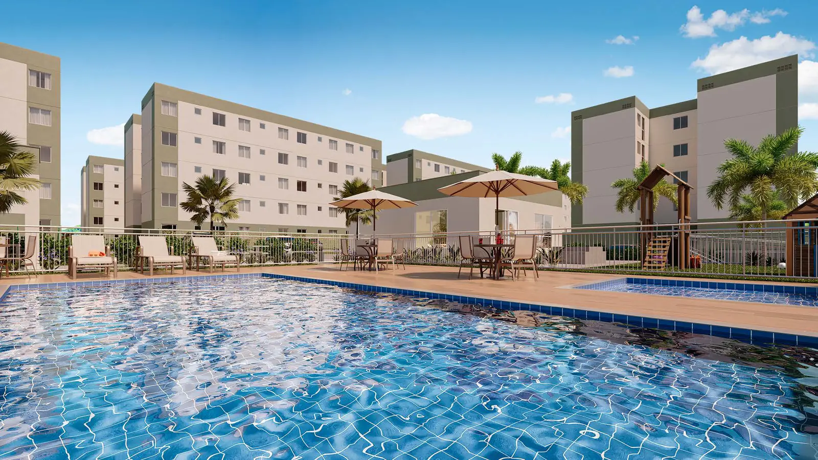 Piscina adulto e piscina infantil do Vitória Jasmim, com deck, espreguiçadeiras e guarda-sóis, e as torres ao fundo