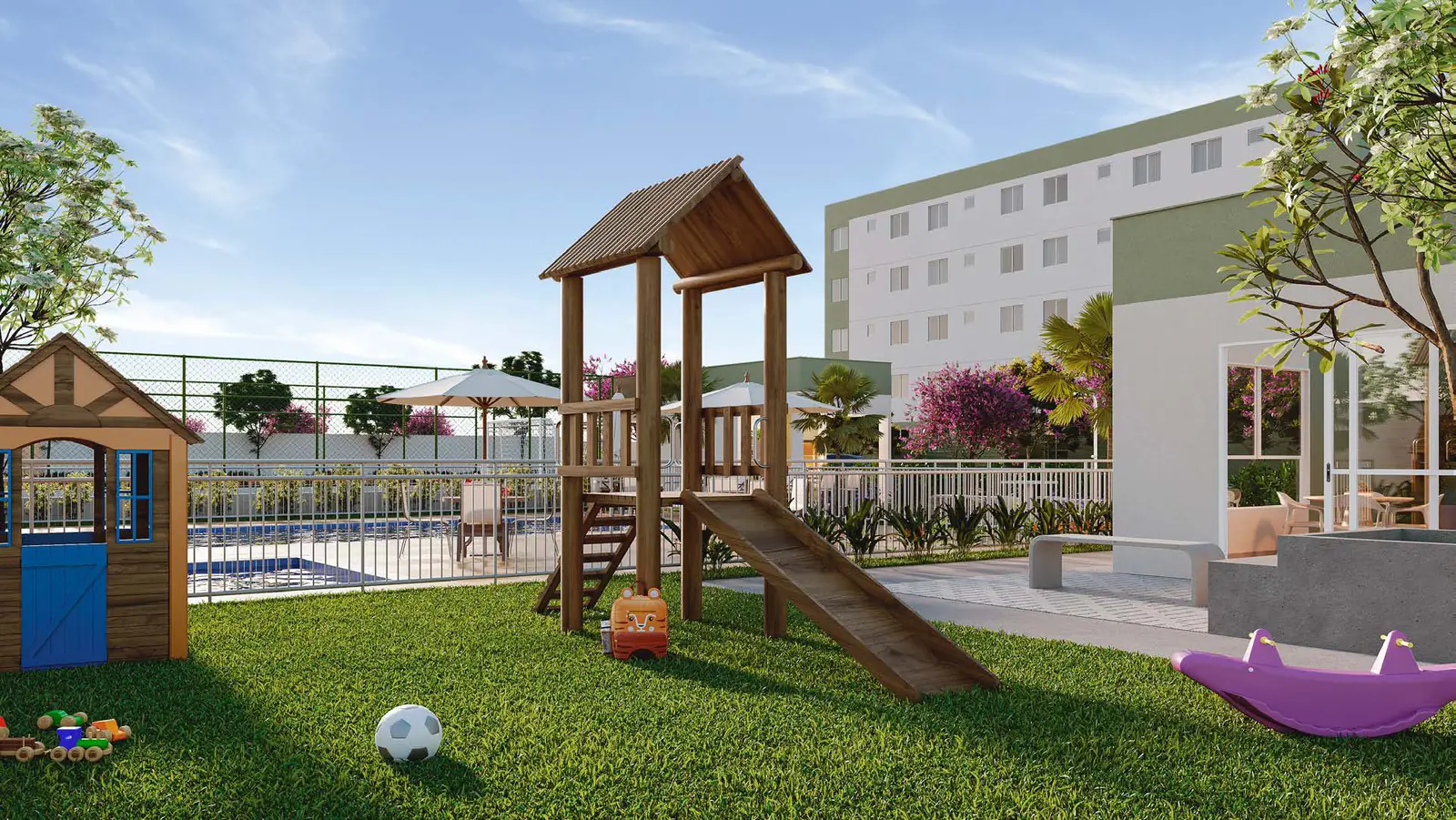 Playground do Vitória Jasmim, com casinha, torre de madeira com escorregador e gangorra sobre a grama